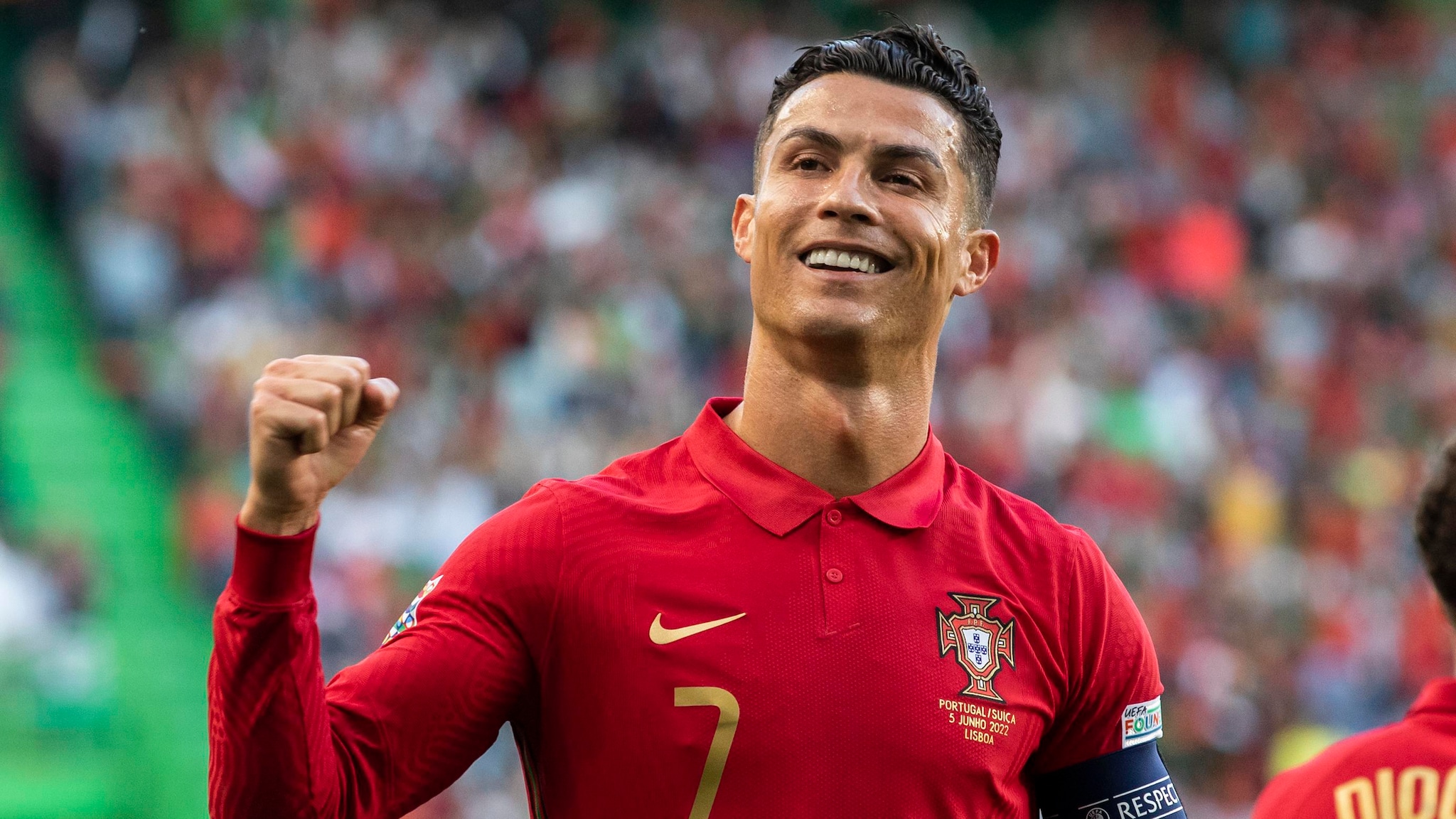 Cristiano Ronaldo in the Portugal national team jersey lifting a trophy