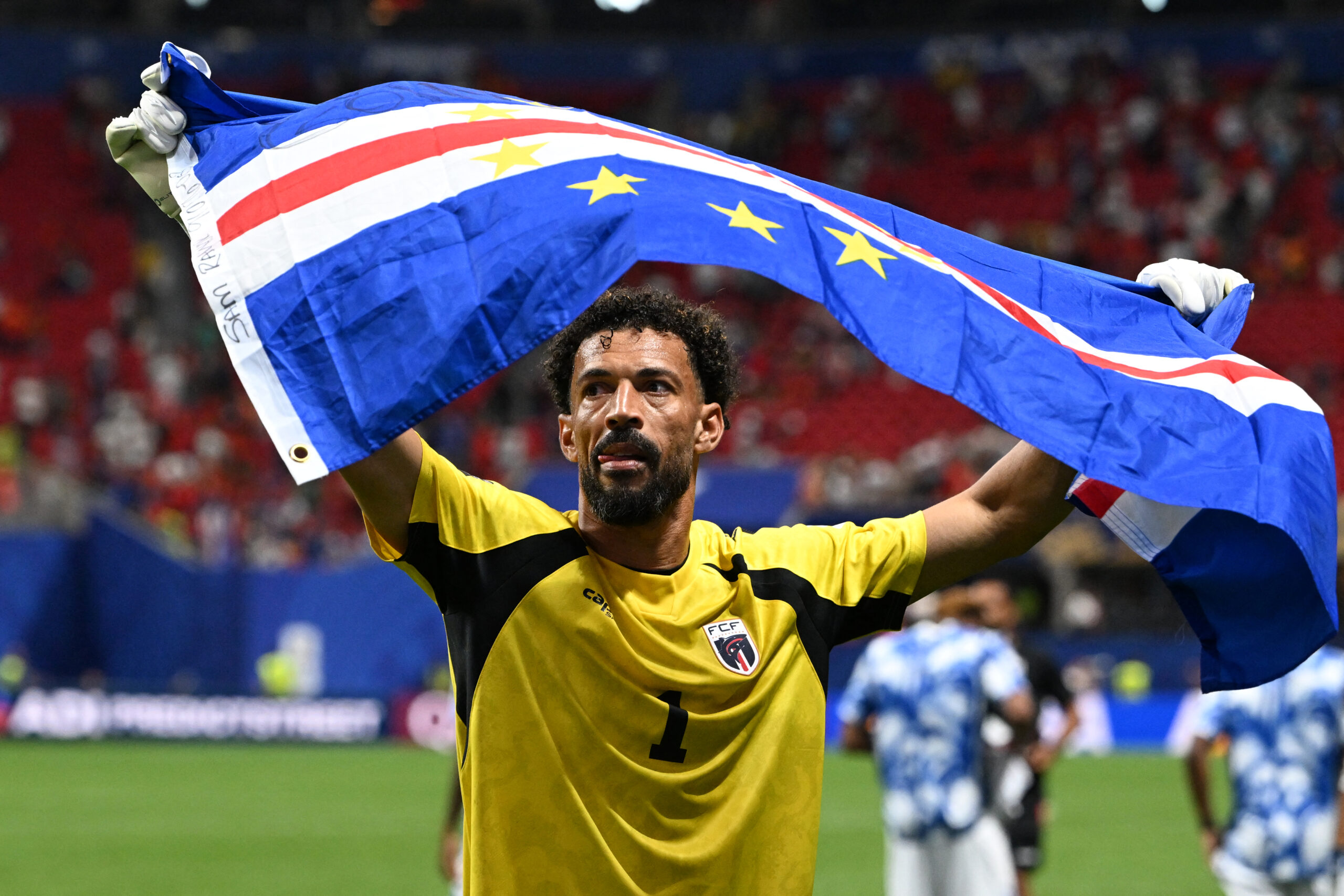 Cape Verde goalkeeper Vozinha celebrates with the national flag at the 2026 World Cup