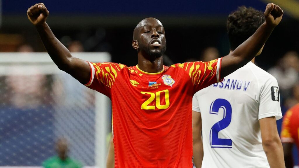 A DR Congo player celebrates in the national team's red kit at the 2026 World Cup, ahead of the Round of 32 tie against England.