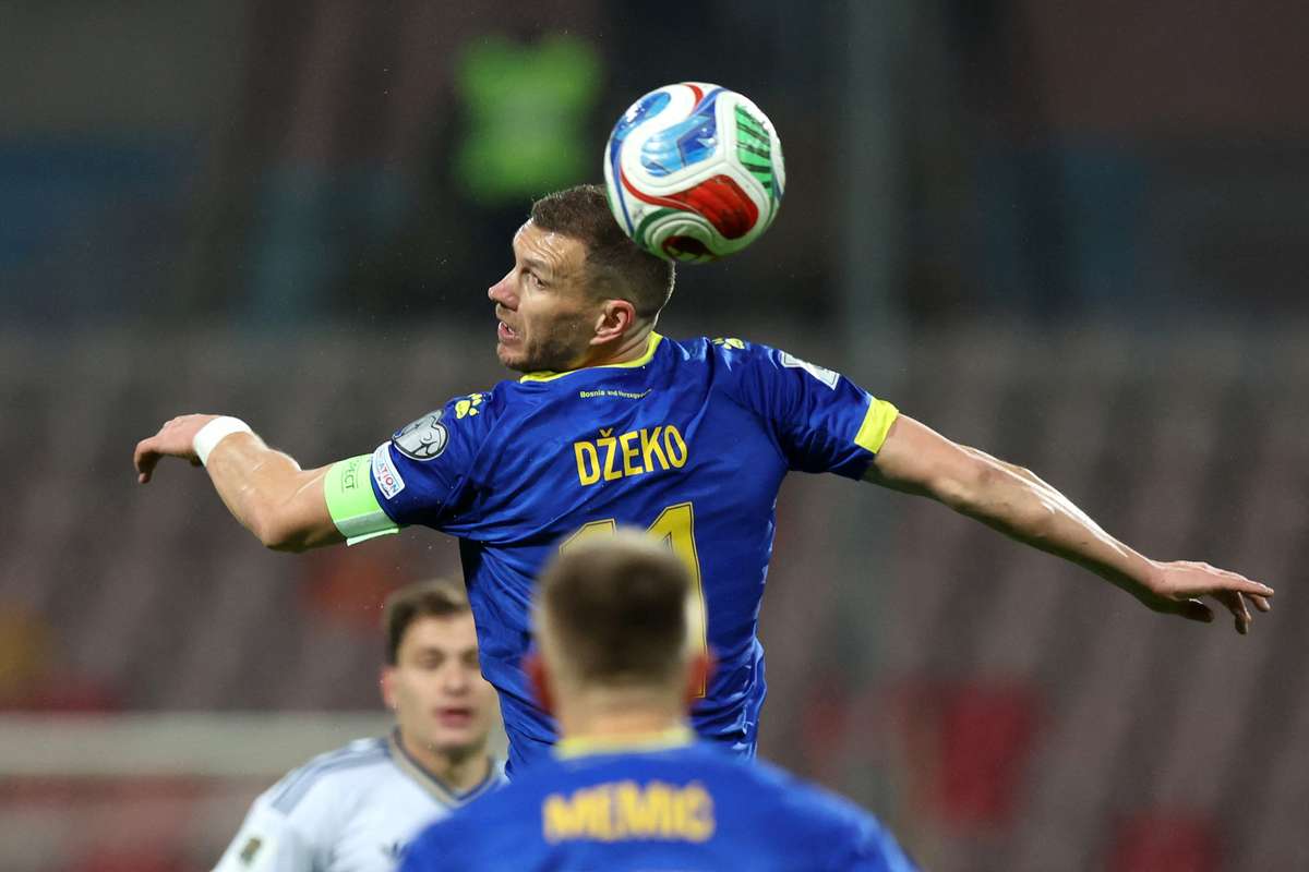 Edin Dzeko heads the ball for Bosnia and Herzegovina