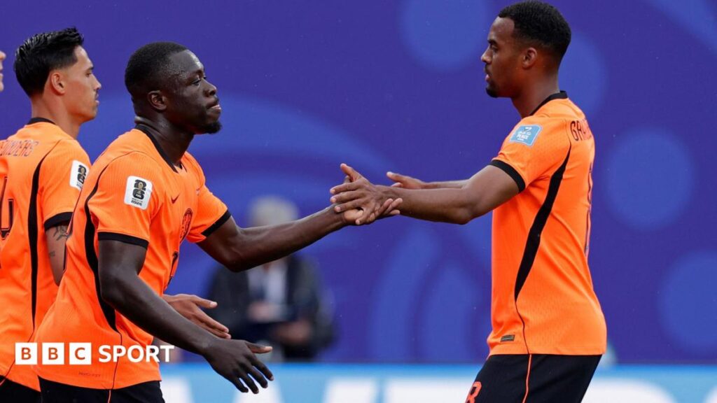 Netherlands players celebrate in their orange home kit; they meet Morocco in the 2026 World Cup Round of 32.