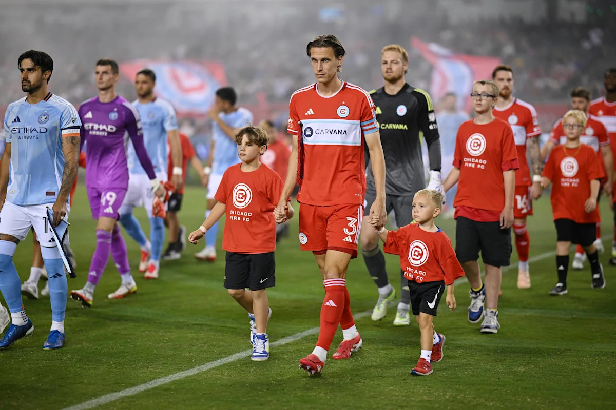 Chicago Fire players walk out in their 2026 home kit before a match against New York City FC