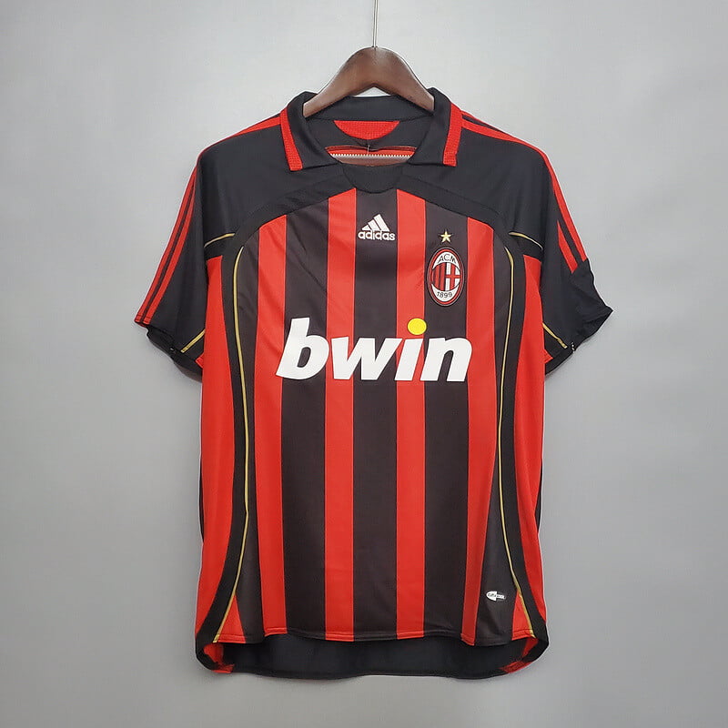 The red and black AC Milan home shirt with gold Adidas shoulder stripes
