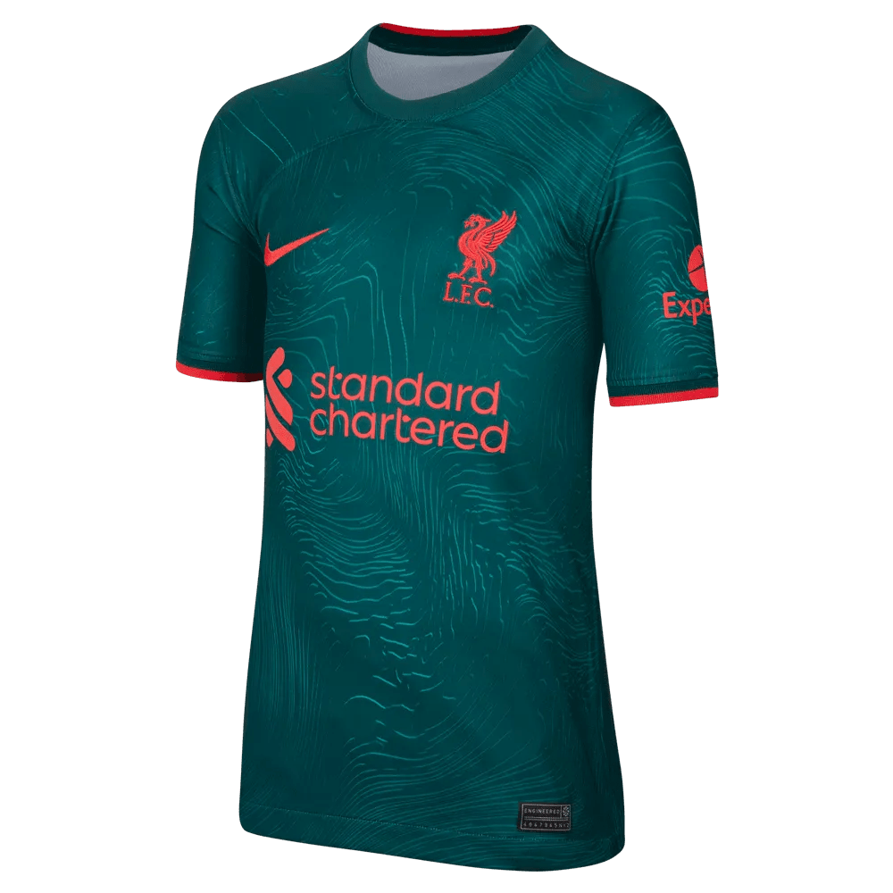 Liverpool players in the dark atomic teal 2022/23 third kit under the Anfield lights