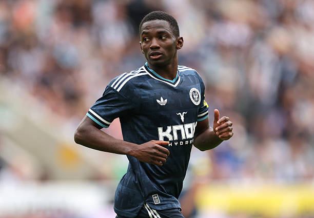 Player in dark Adidas kit with Knox Hydra sponsor runs on pitch