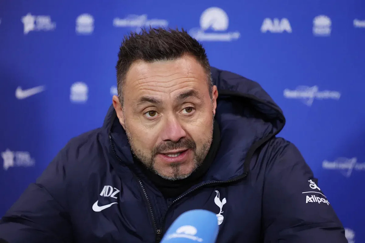 Roberto De Zerbi speaking at a Tottenham press conference in a club coat