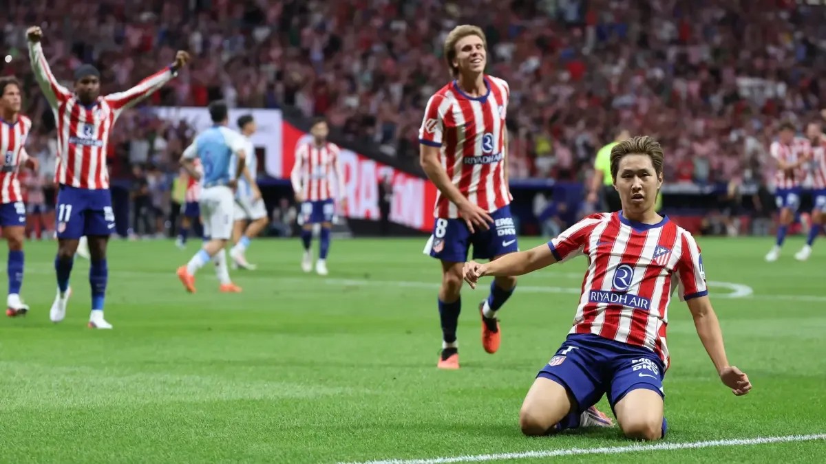 Lee Kang-In slides to his knees celebrating his goal for Atletico Madrid against Malaga at the Metropolitano