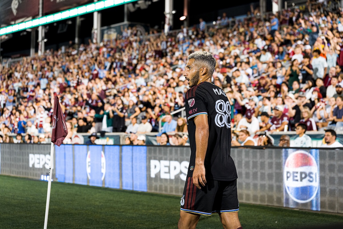 Colorado Rapids player by the corner flag in front of a full stand