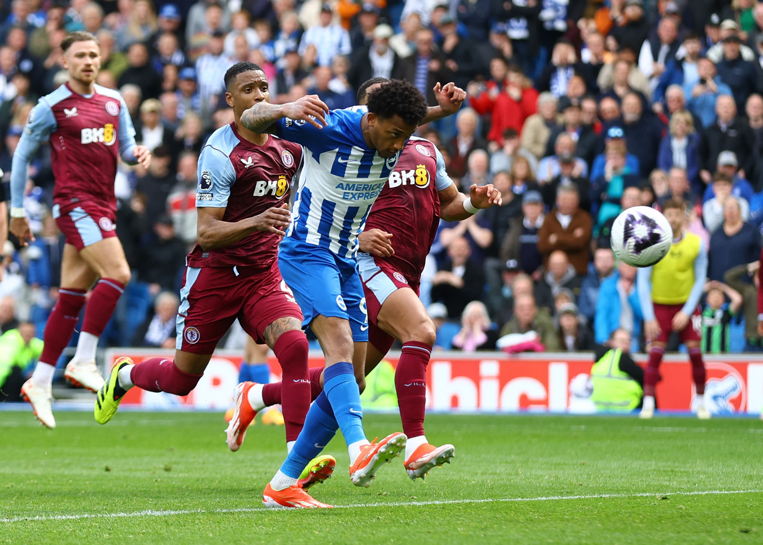 Aston Villa and Brighton players compete for the ball in a Premier League match