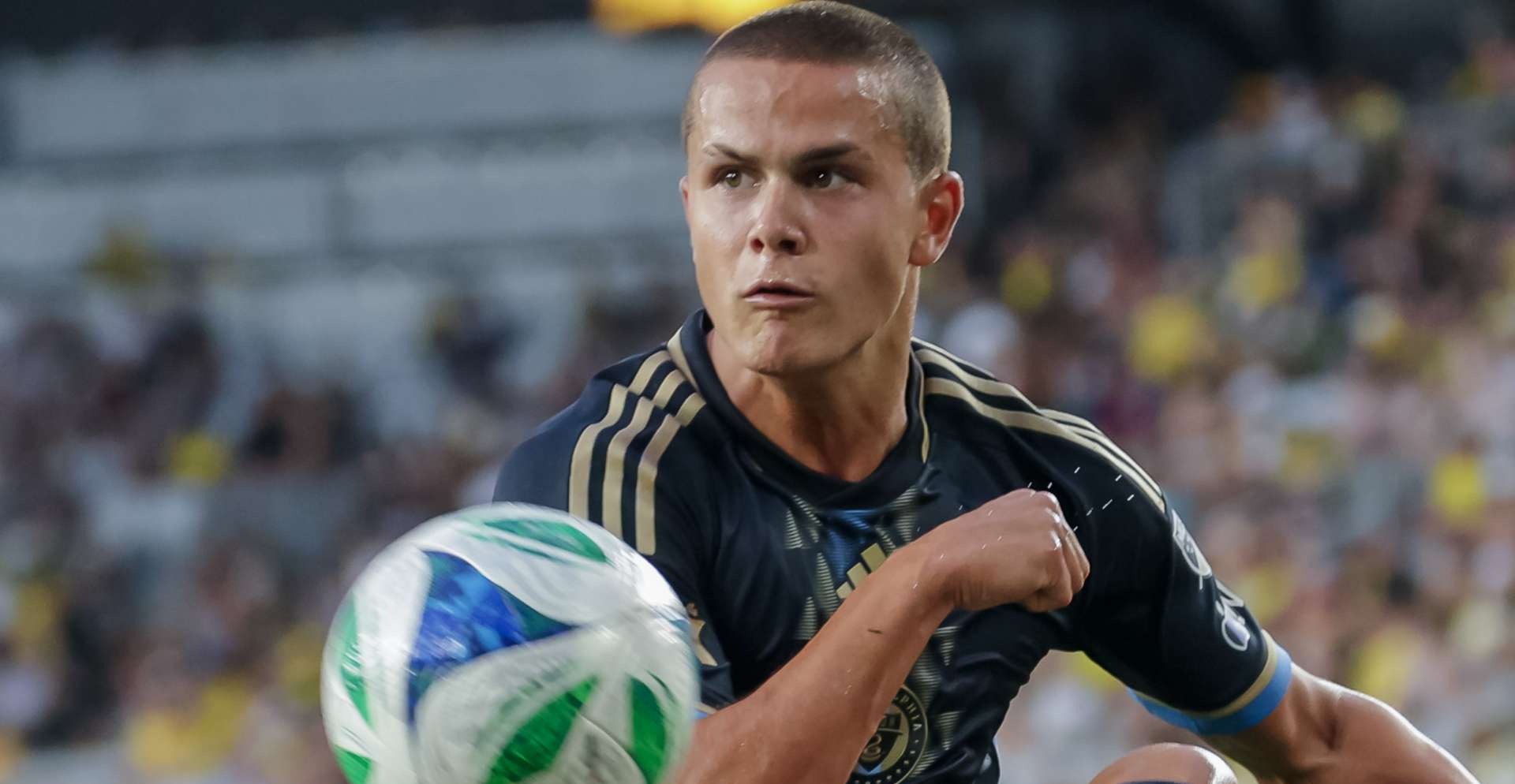 Philadelphia Union player looks up with the ball at his feet