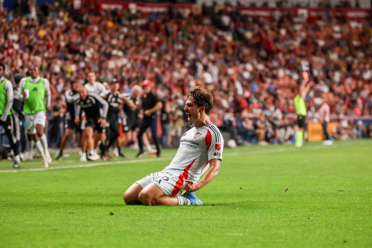 FC Dallas player slides in to reach the ball during an MLS match