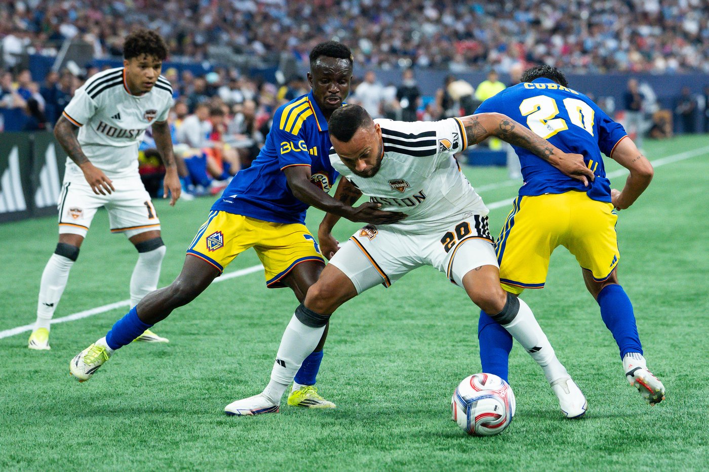 Houston Dynamo’s Guilherme battles Vancouver Whitecaps’ Cheick Sabaly and Andres Cubas during Houston’s 1-0 win at BC Place on August 19, 2026